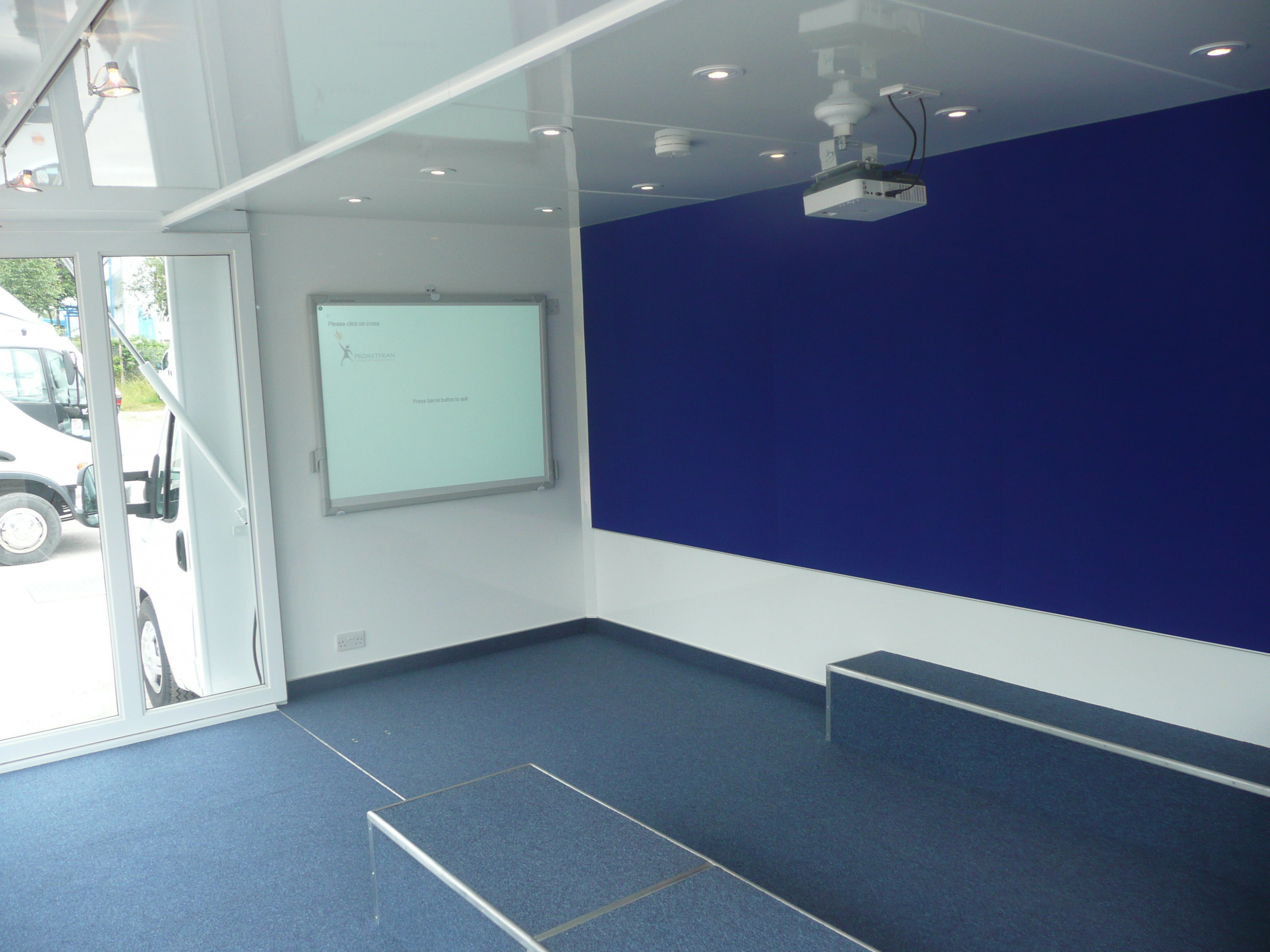 Children in Crisis mobile classroom showing interactive whiteboard before furniture was loaded