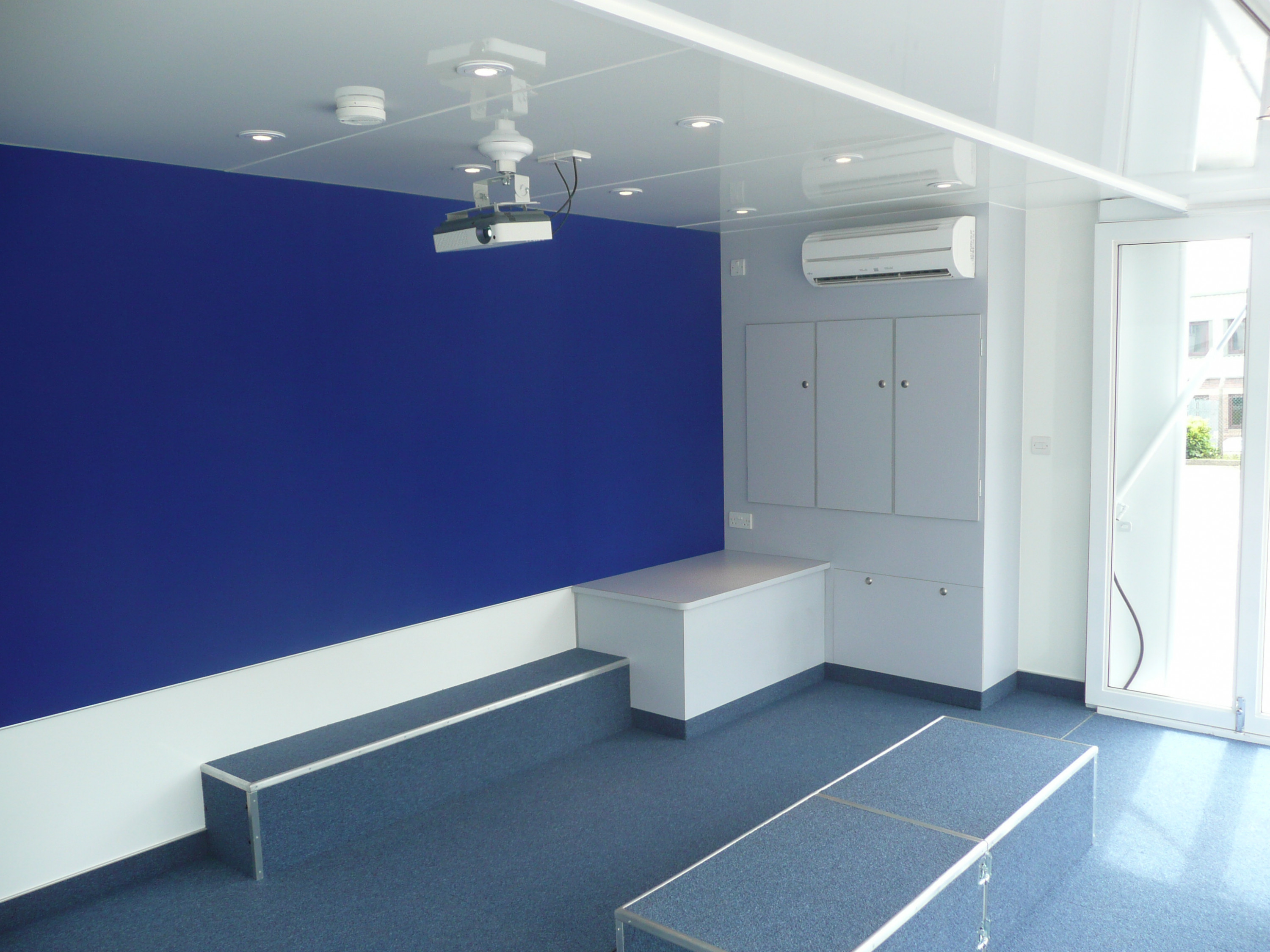 Children in crisis mobile classroom before all the furniture went in