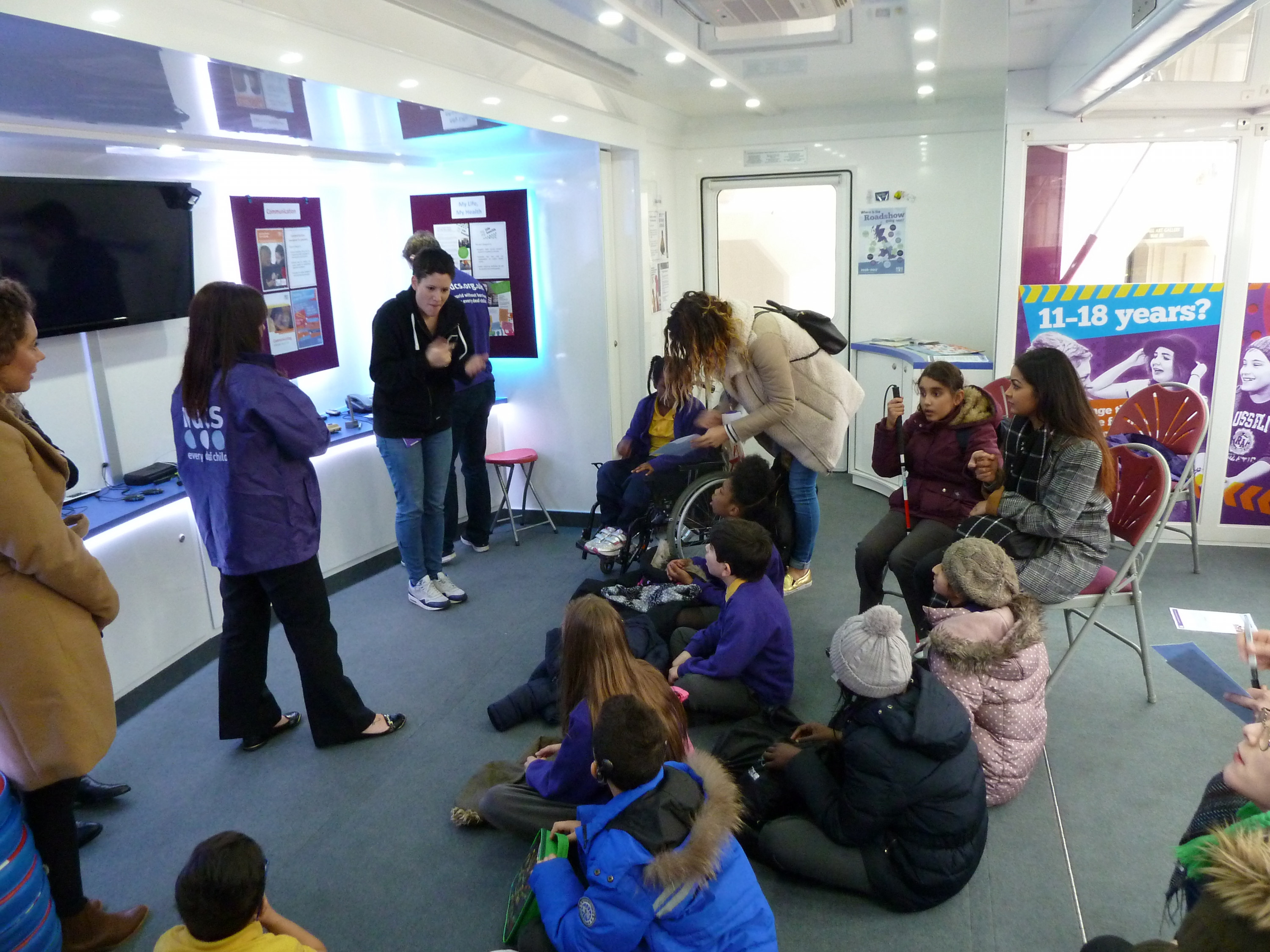 National Deaf Children Society Listening Bus inside view with children watching a presentation