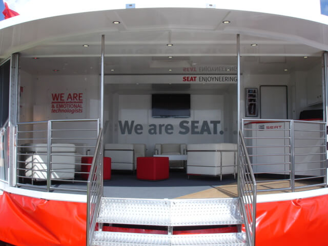 Seat-mobile-exhibition-unit-set-up-with-open-stage-showing-furniture-laid-out-in-hospitality-mode